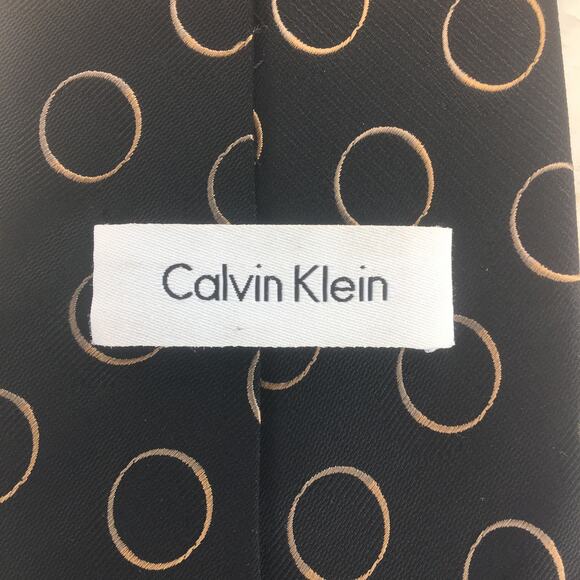 CALVIN KLEIN GOLD AND SILVER RINGS ON BLACK ALL SILK NECKTIE - Picture 4 of 12